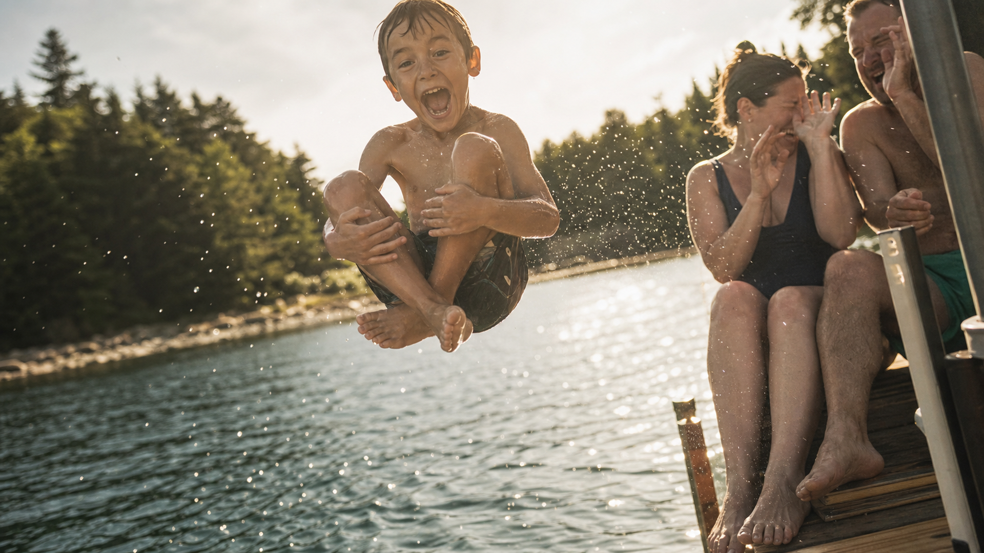 A kid mid-cannonball off a dock, frozen in a warm afternoon frame